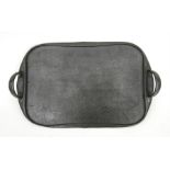 A Liberty & Co. beaten pewter two-handled rectangular tray, 46cms (18ins) wide.