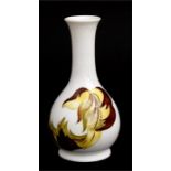 A Moorcroft pottery vase decorated flowers. 15cm (6ins) high