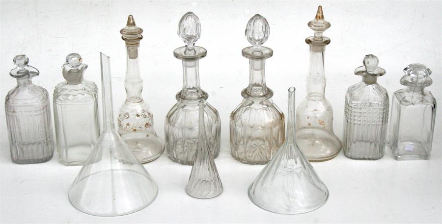 A pair of Victorian mallet shaped decanters, 27cms (10.5ins) high; a quantity of other decanters and