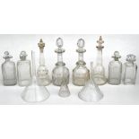 A pair of Victorian mallet shaped decanters, 27cms (10.5ins) high; a quantity of other decanters and