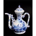 A faience blue & white pottery ewer decorated with 18th century figures in a landscape, 27cms (10.