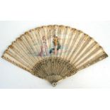 An 18th century ivory fan, the guards carved with figures and inlaid with silver, the sticks well