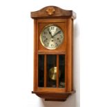 An oak cased wall clock, 35cms (13.75ins) wide.