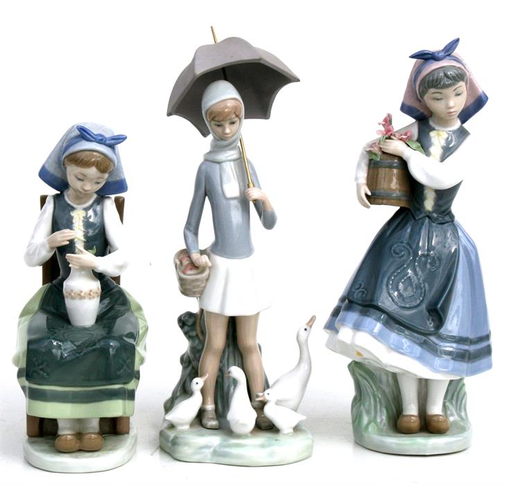 Three Lladro figures, Girl with Ducks, Girl with Flowers and Girl with Vase, the largest 27cms (10.