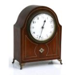 An Edwardian mantle clock, the white enamelled dial with Arabic numerals in an inlaid mahogany case,
