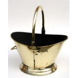 A brass coal scuttle.