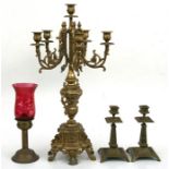 A five-arm brass candelabrum, 60cms (23.5ins) high; a pair of Victorian brass candlesticks, 21cms (