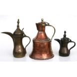 A Turkish / Islamic brass dallah coffee pot, 32cms (12.5ins) high; together with another smaller