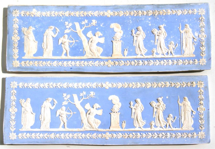 A pair of Wedgwood Jasperware style panels decorated with classical scenes, 46cms (18ins) wide.