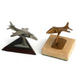 A brass model of a Harrier Jump Jet standing on a marble base, wingspan 6cms (2.25ins) and a