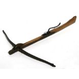An early 19th century style crossbow. Overall length 63.5cms (25ins) by 60cms (23.5ins) across the