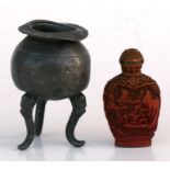 A Chinese pewter censer of globular form, on three lion mask capped legs, 9cms (3.5ins) high;