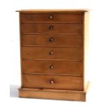 A stripped pine miniature collectors chest with six long graduated drawers, on plinth base, 37cms (