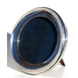 A circular silver strut photograph frame, Birmingham 1924, to hold a photo 18cms (7ins) diameter.