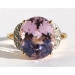 A 9ct gold dress ring set with a large pink central stone and diamond shoulders, approx UK size '