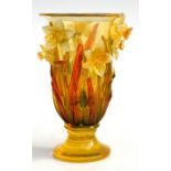 Mid 20th century design, a yellow plastic vase decorated with applied daffodils, 19cms (7.5ins)
