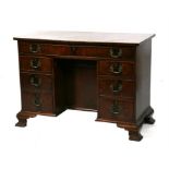 A Georgian style mahogany kneehole desk with an arrangement of seven drawers, 108cms (42.5ins)