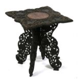 A carved hardwood occasional table decorated with grapes & vines, on pierced quatrefoil supports,