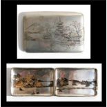 A Japanese sterling silver cigarette case decorated with a landscape, 12cms (4.25ins) wide.