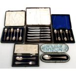 A quantity of cased silver cutlery to include tea spoons and silver handled butter knives.