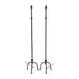 A pair of wrought iron standard lamps, 113cms (44.5ins) high.