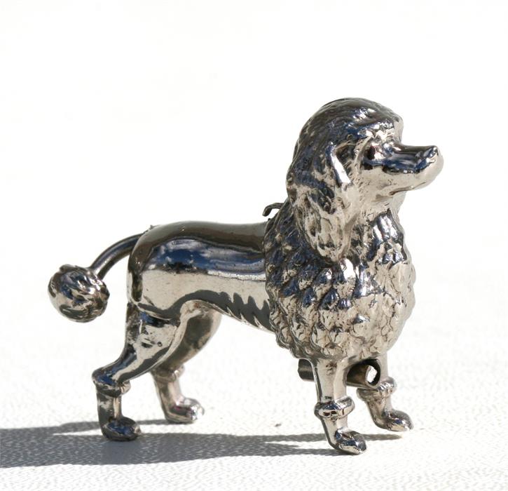 A novelty sewing tape measure in the form of a poodle, 5cms (2ins) long. Condition Report Tape worn,