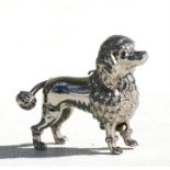 A novelty sewing tape measure in the form of a poodle, 5cms (2ins) long. Condition Report Tape worn,
