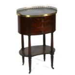 A French mahogany nightstand, the oval black marble top above three drawers, on turned supports with