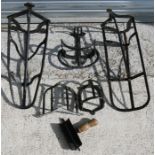 A quantity iron saddle racks and tack holders.