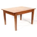 A pine kitchen table with single drawer, on square tap legs, 122cms (48ins) wide.