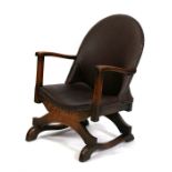 An early 20th century leatherette upholstered easy chair.