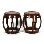 A pair of 20th century Chinese hardwood drum stools, 41cms (16ins) diameter.