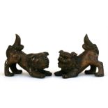 A pair of Chinese bronze lions, 15cms (6ins) long.