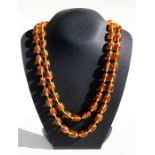 A Baltic amber bead necklace, each bead approx 1.5cms long.