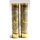 A matching pair of WW1 trench art brass shell case vases elaborately decorated with embossed acorns.