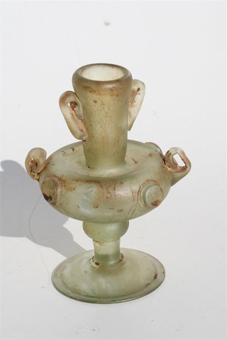 A hand blown Romanesque two-handled glass vase, 15cms (6ins) high. - Image 2 of 2