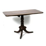 An ealry 19th Century snap top table of rectangular form on turned column and tripod legs. 112cm (