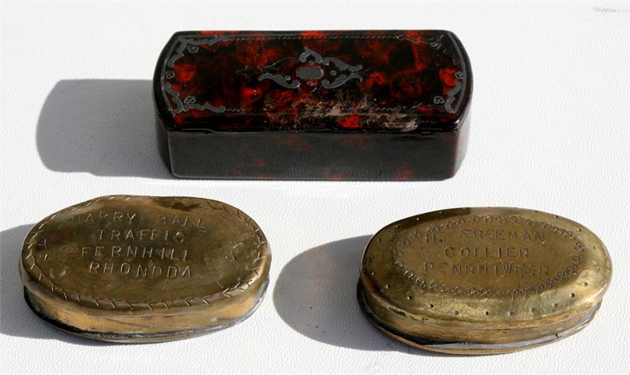 A brass snuff box inscribed 'H Freeman, Collier'; together with another similar inscribed 'Harry