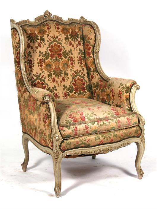 A French carved and distressed painted upholstered armchair. Condition Report It has been re-