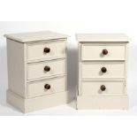 A pair of modern painted pine three-drawer bedside cabinets, 51cms (20ins) wide.