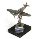 A chrome plate model of the Supermarine Spitfire mounted on a chrome and marble base. Wingspan of