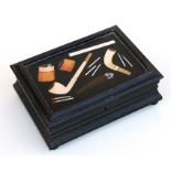 A late 19th century pietra dura inlaid marble topped ebonised cigarette box decorated with pipes,