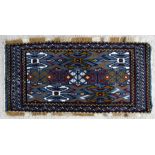 A handmade Persian Baluch rug with geometric design on a blue ground, 105 by 50cms (41 by 19.5ins).