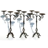 Three wrought iron Gothic style triple arm candelabra, 46cms (18ins) high (3).