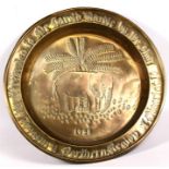 A large African brass tray decorated with a central elephant with inscription 'Presented to Mr