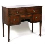A Georgian mahogany sideboard having two frieze drawers with drawer beneath and cupboards beside,