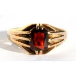 A 9ct gold ring set with a large rectangular garnet, approx UK size 'X'.