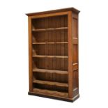 A large oak continental open bookcase with six shaped shelves on a plinth base, 128cms (50.5ins)