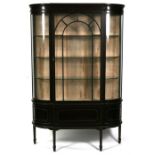 An Edwardian mahogany display cabinet, the astragal glazed door enclosing a shelved interior, on
