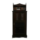 A Victorian cabinet, the carved & glazed door enclosing a shelved interior, 53.5cms (21ins) wide.